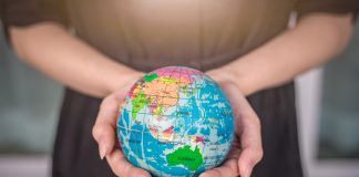 Swintt boosts global reach with SkillOnNet link-up Woman holding globe