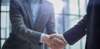 Elantil secures live casino boost with Animo link-up Businessmen shake hands