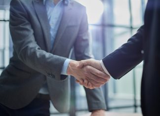 Elantil secures live casino boost with Animo link-up Businessmen shake hands