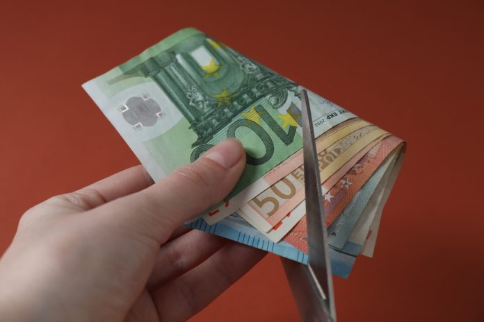 Kenya Scissors cut through money