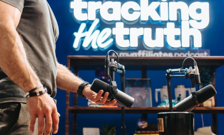 A man fixes the microphones for a Tracking the Truth episode.