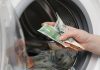 The Philippines eyes strengthened AML enforcement against online gambling Close up of hand putting money into a washing machine