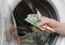 The Philippines eyes strengthened AML enforcement against online gambling Close up of hand putting money into a washing machine