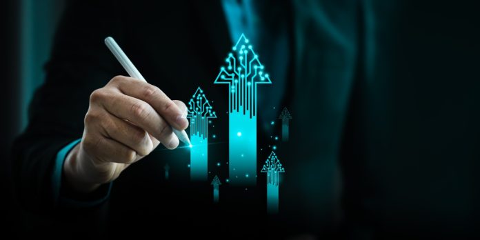 A pen draws digital upwards going lines to illustrate Fincore's development.