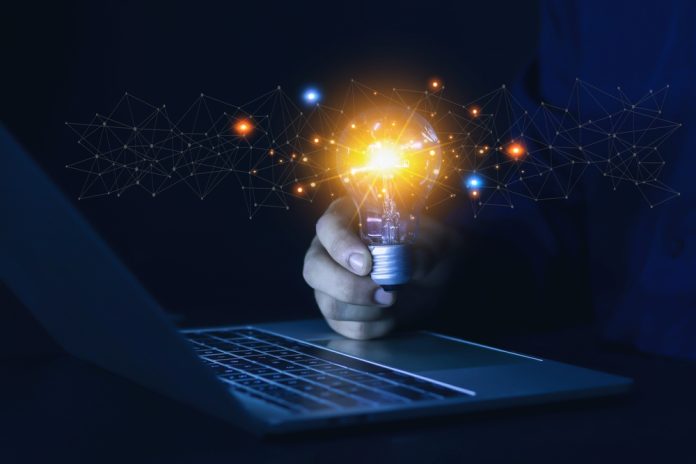 Concept,Businessman,Holding,A,Light,Bulb,With,Innovation,And,Inspiration Lightbulb representing product devlopment as Galaxsys discusses slot games