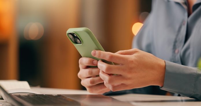 Business,,Person,Or,Hands,With,Phone,Texting,Email,In,Office Man using mobile as Zenith Chats About mobile casino experiences in Brazil