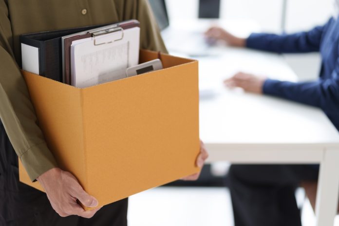 A,Person,Carrying,A,Box,Filled,With,Office,Supplies,,Including Dismissal