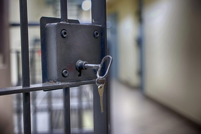 Key in the lock of a jail cell
