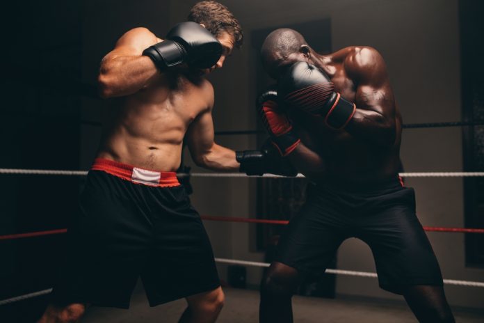 Man,Punching,The,Stomach,Of,His,Opponent,During,A,Boxing Boxing