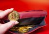 ReferOn steps up crypto capabilities with new payments layer Hand holds a gold coin with bitcoin logo
