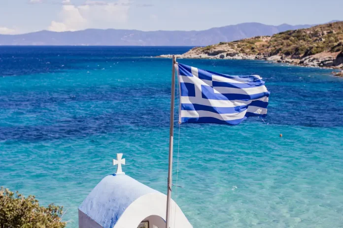 Amusnet Greece Greek flag with ocean in background