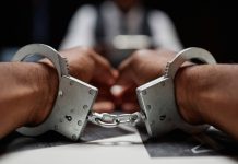Alleged Chinese casino kingpin arrested in Thailand Close up of handcuffs