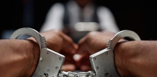Alleged Chinese casino kingpin arrested in Thailand Close up of handcuffs