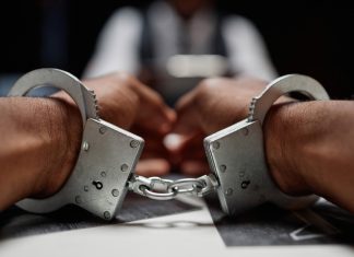 Alleged Chinese casino kingpin arrested in Thailand Close up of handcuffs