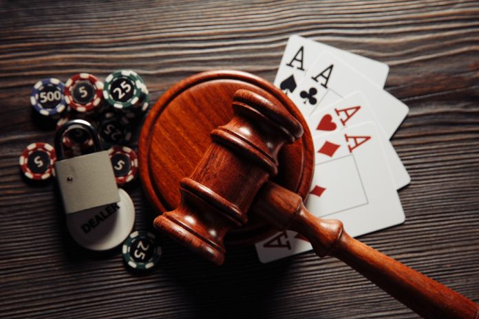 Eswatini illegal gambling Gavel with cards and poker chips