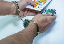 ‘To save youth from destruction’, Bangladesh vows no leniency for illegal gambling Man in handcuffs holds out cards and poker chips