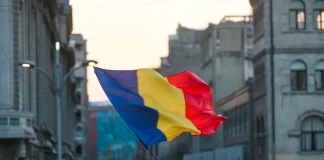 Soft2Bet unites casino and sports betting with new Romanian launch Romania flag in front of a city backdrop