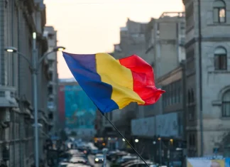 Soft2Bet unites casino and sports betting with new Romanian launch Romania flag in front of a city backdrop