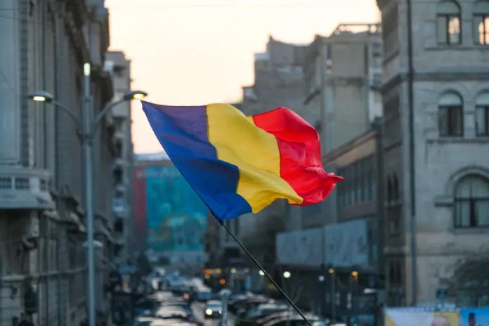 Romania flag in front of a city backdrop