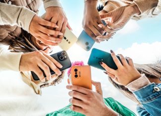 Ygam warns students increasingly being influenced by social media gambling Students looking at phones