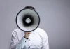 Gambling Commission ‘increasingly vocal’ against companies failing in black market fight Close up of a man shouting through a megaphone