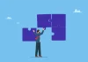 Kanggiten: Where operators lose players and how platform architecture can stop the bleed A man fixing puzzle pieces, illustrating Kanggiten and their PAM strategy.