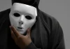 MGA battles back against false licensing claims Man holdimg white mask