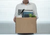 South African gambling regulator fired for ‘gross misconduct’ Man holding box leaving job