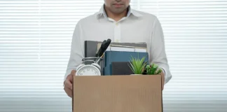 South African gambling regulator fired for ‘gross misconduct’ Man holding box leaving job