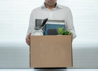 South African gambling regulator fired for ‘gross misconduct’ Man holding box leaving job