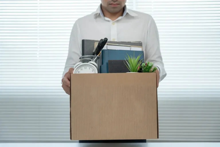 Man holding box leaving job