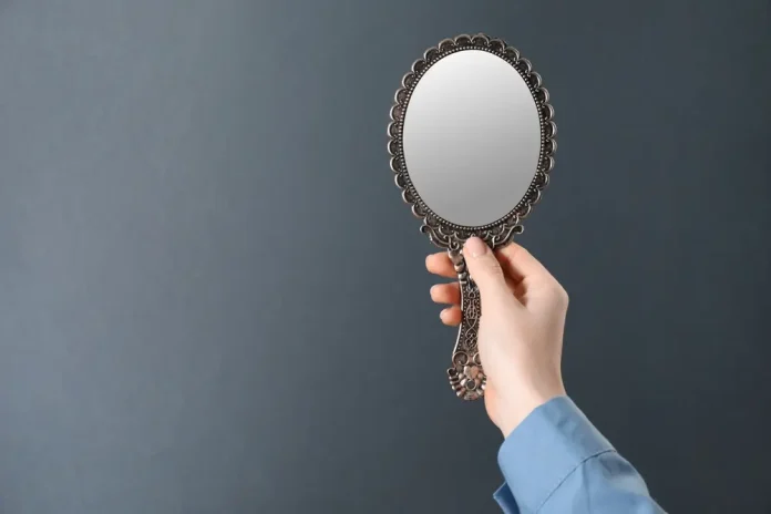 mirror Woman holding up mirror