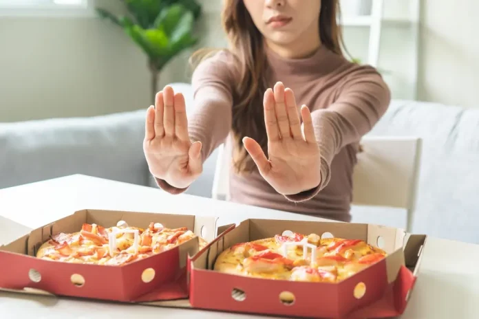 Woman pushes away food