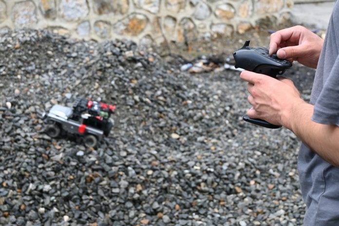 Remote control car being controlled by someone stood offscreen