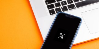 X: betting integrations, AI and building communities for brand engagement X logo displayed on a mobile phone