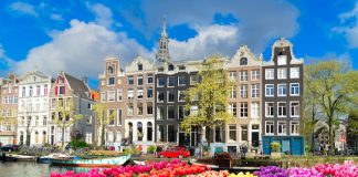 Gaming in Holland Conference 2026 to spotlight channelisation Facades of old historic Houses and trees over canal water, Amsterdam, Netherlands