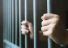 Ex-Senator’s son jailed for 132 years in Thailand amid illegal gambling crackdown Man holds on to railing of a jail cell