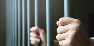 Ex-Senator’s son jailed for 132 years in Thailand amid illegal gambling crackdown Man holds on to railing of a jail cell