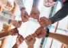 Entain commits to working with ACMA amid regulatory challenges Hands in a circle signifying team work