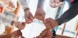 Entain commits to working with ACMA amid regulatory challenges Hands in a circle signifying team work