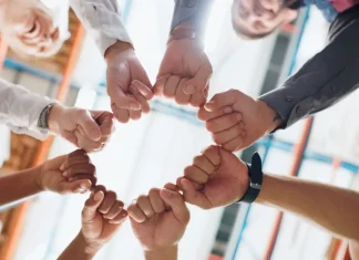Entain commits to working with ACMA amid regulatory challenges Hands in a circle signifying team work