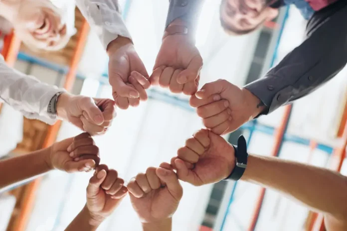 Hands in a circle signifying team work