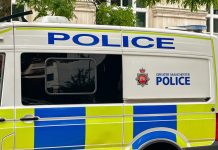 Two arrested in Manchester gambling den raid Greater Manchester Police van