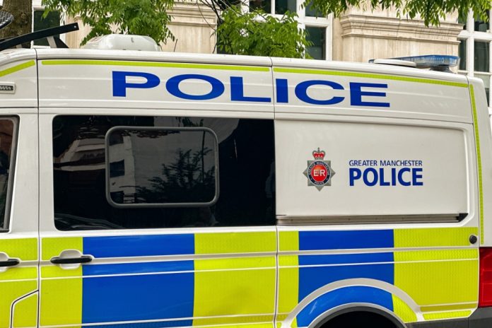 Manchester illegal gambling raid Greater Manchester Police van