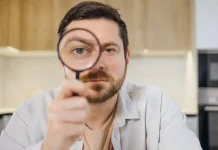 Report calls for UK regulator investigation over black market inaction Man looks through magnifying glass