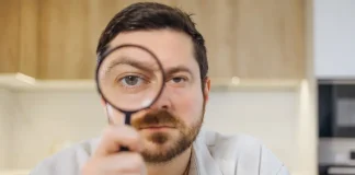 Report calls for UK regulator investigation over black market inaction Man looks through magnifying glass
