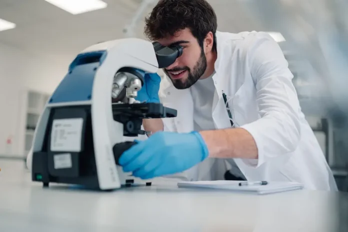 Scientist looking through microscope