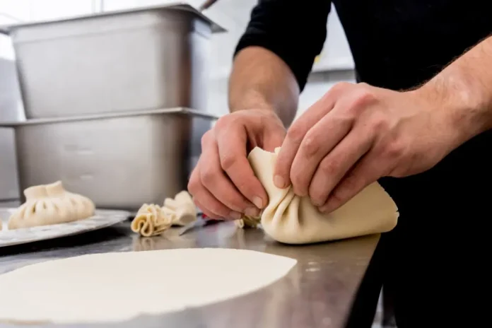 Dough being reshaped by hand