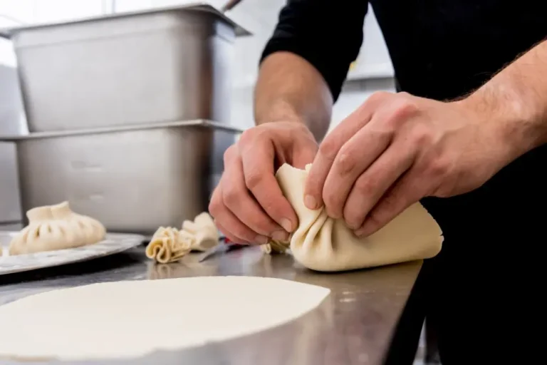 Dough being reshaped by hand